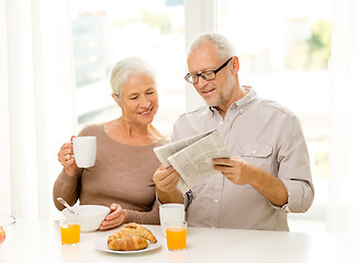 Image showing happy senior couple having breakfast at home