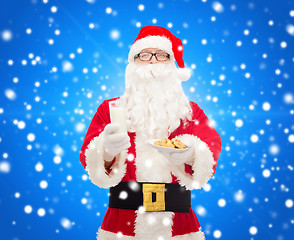 Image showing santa claus with glass of milk and cookies