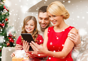 Image showing smiling family with tablet pc at home