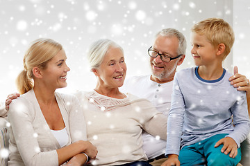 Image showing happy family sitting on couch at home