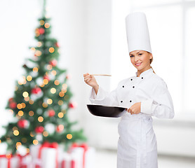 Image showing smiling female chef with pan and spoon