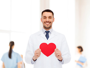 Image showing smiling male doctor with red heart