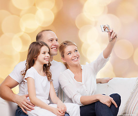 Image showing happy family with camera at home