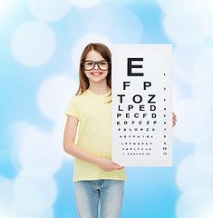 Image showing little girl in eyeglasses with eye checking chart