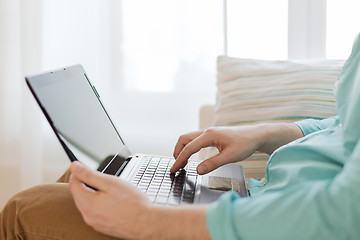 Image showing close up of man working with laptop at home