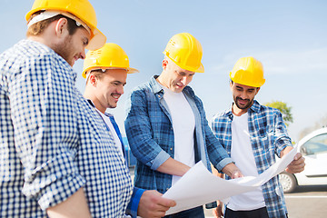 Image showing group of builders with tablet pc and blueprint