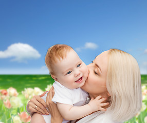 Image showing happy mother kissing smiling baby