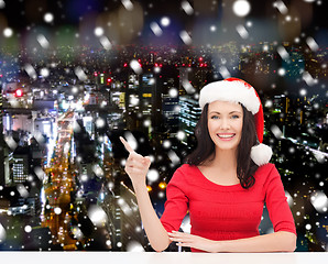 Image showing smiling woman in santa helper hat