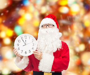 Image showing man in costume of santa claus with clock