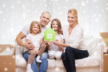 Image showing smiling parents and two little girls at new home