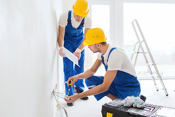 Image showing builders with tablet pc and equipment indoors