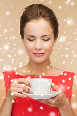 Image showing smiling woman in red dress with cup of coffee