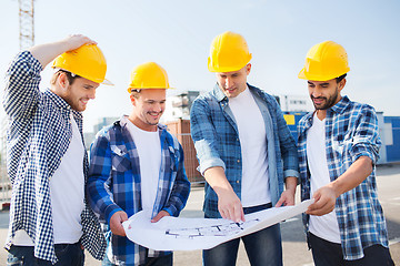 Image showing group of builders with tablet pc and blueprint