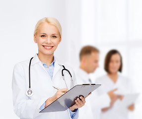 Image showing smiling female doctor with clipboard