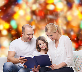 Image showing happy family with book at home