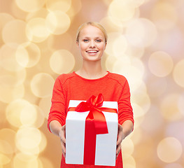 Image showing smiling woman in red clothes with gift box