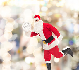 Image showing man in costume of santa claus with clock