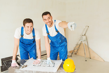 Image showing group of builders with blueprint