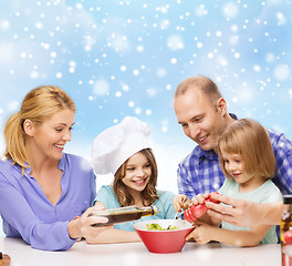 Image showing happy family with two kids making salad at home