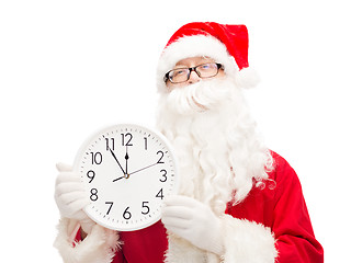 Image showing man in costume of santa claus with clock