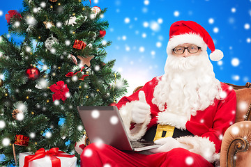 Image showing man in costume of santa claus with laptop