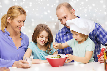 Image showing happy family with two kids making salad at home