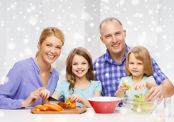 Image showing happy family with two kids making dinner at home