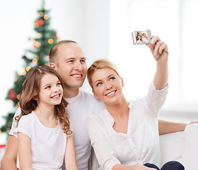 Image showing happy family with camera at home