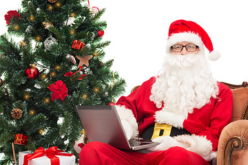 Image showing man in costume of santa claus with laptop