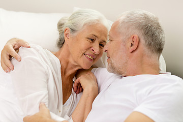 Image showing happy senior coupler lying in bad at home