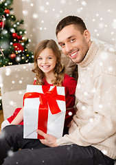 Image showing smiling father and daughter holding gift box