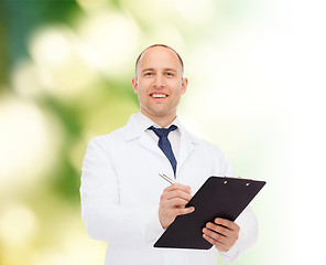 Image showing smiling male doctor with clipboard