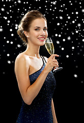 Image showing smiling woman holding glass of sparkling wine