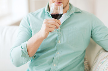 Image showing close up of man drinking wine at home