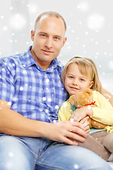 Image showing smiling father and daughter with teddy bear