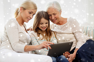 Image showing smiling family with tablet pc at home