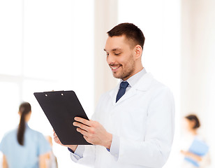 Image showing smiling male doctor with clipboard