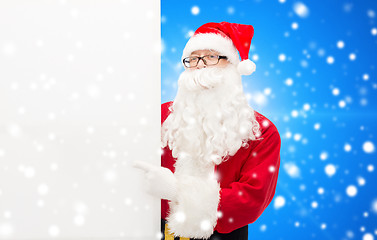 Image showing man in costume of santa claus with billboard