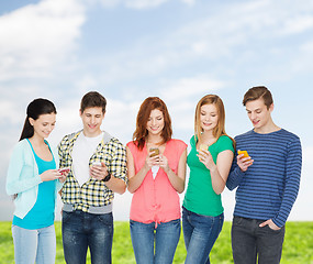 Image showing smiling students with smartphones