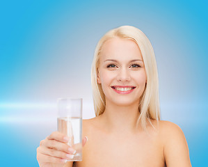 Image showing young smiling woman with glass of water