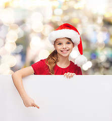 Image showing girl in santa helper hat with blank white board