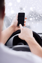 Image showing close up of man using smartphone while driving car