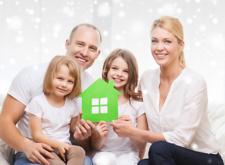 Image showing happy family with two kids and paper house at home