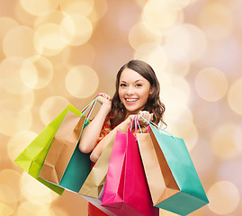 Image showing smiling woman with colorful shopping bags