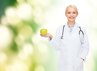 Image showing smiling female doctor with green apple