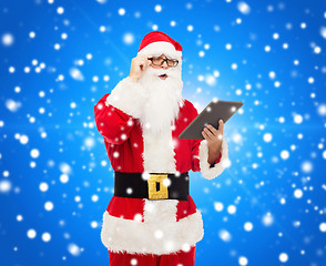 Image showing man in costume of santa claus with tablet pc