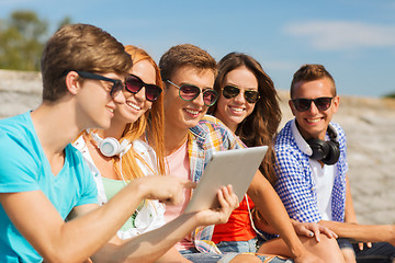 Image showing group of smiling friends with tablet pc outdoors