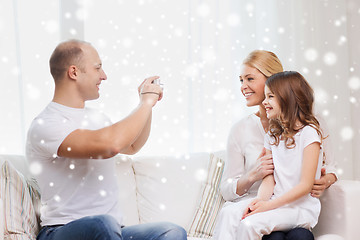 Image showing happy family with camera taking picture at home