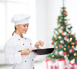 Image showing smiling female chef with pan and spoon