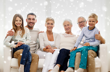 Image showing happy family sitting on couch at home